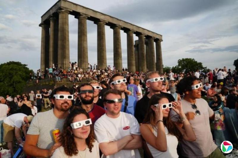 爱丁堡卡尔顿山(Calton Hill)聚集大批民众观赏日食,但他们不得不与多云天气周旋,等待云层散开的一刻。
